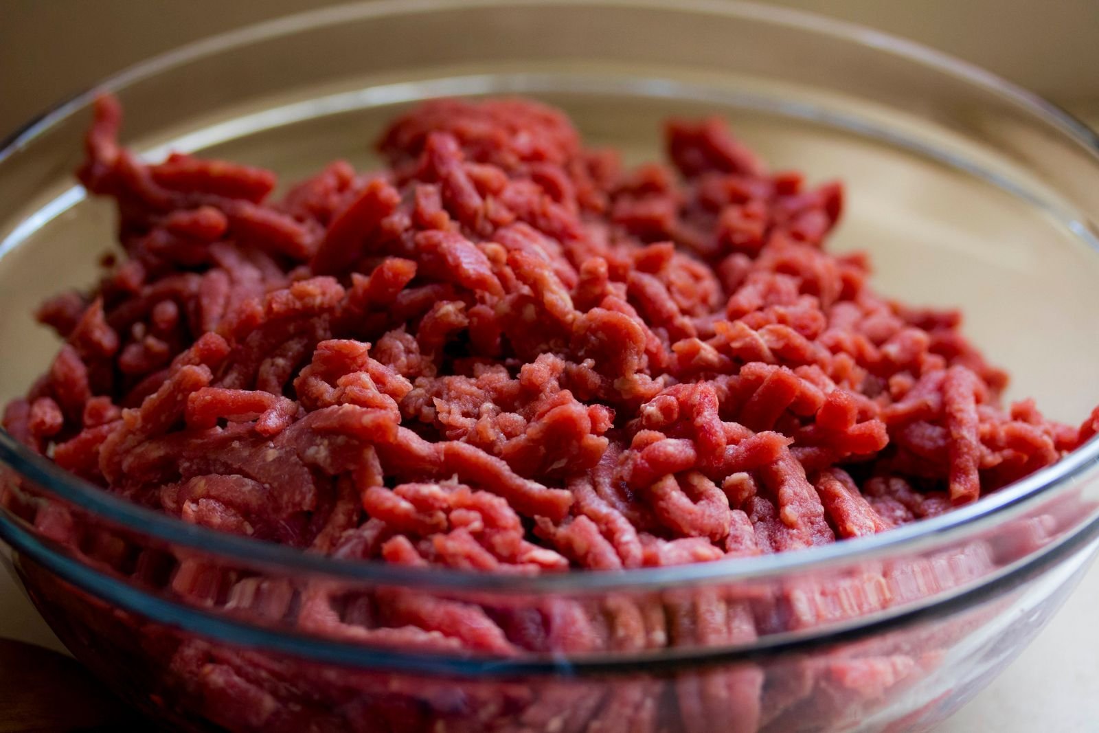 Glass bowl filled with freshly ground raw beef