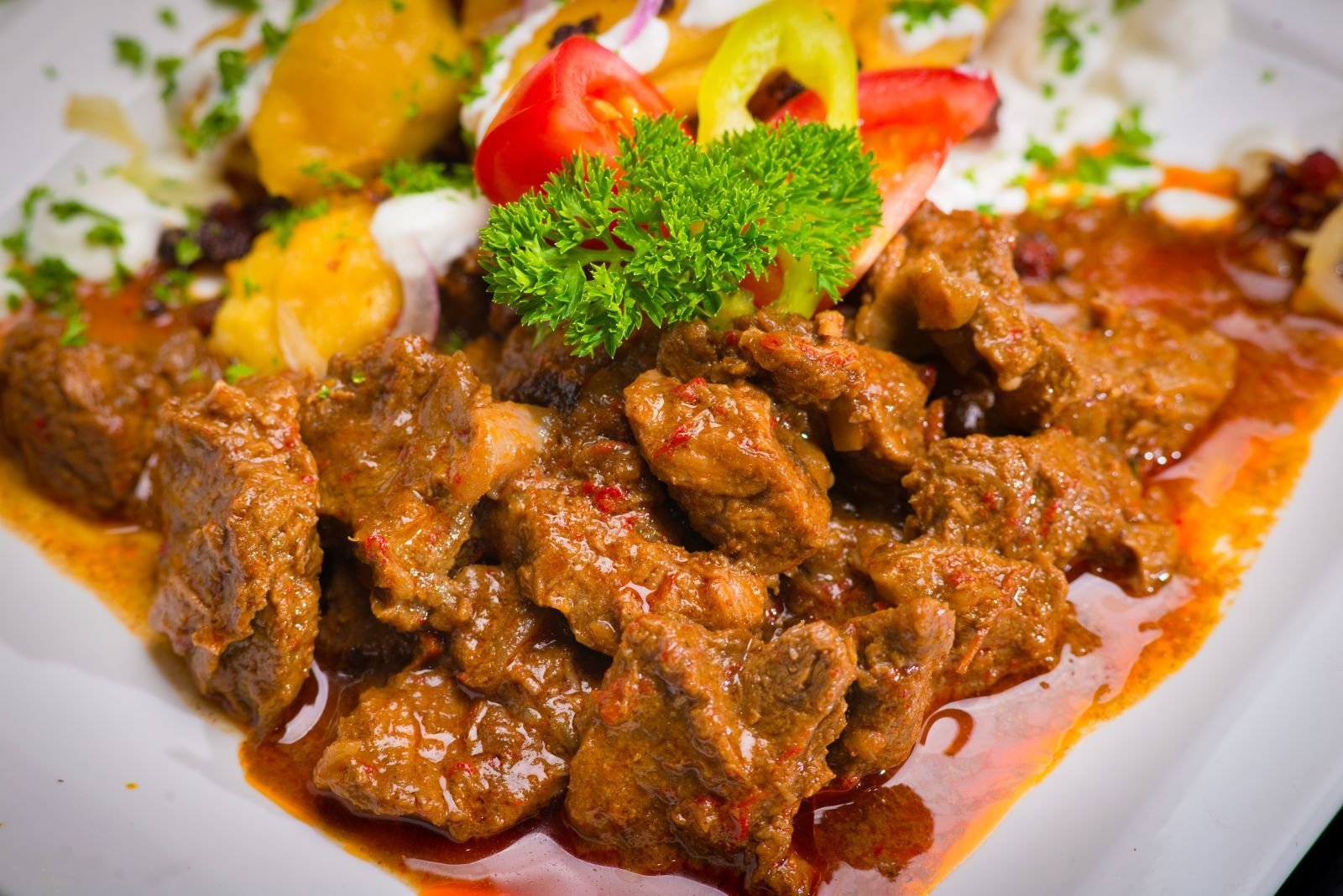 Beef goulash chunks in paprika sauce with parsley