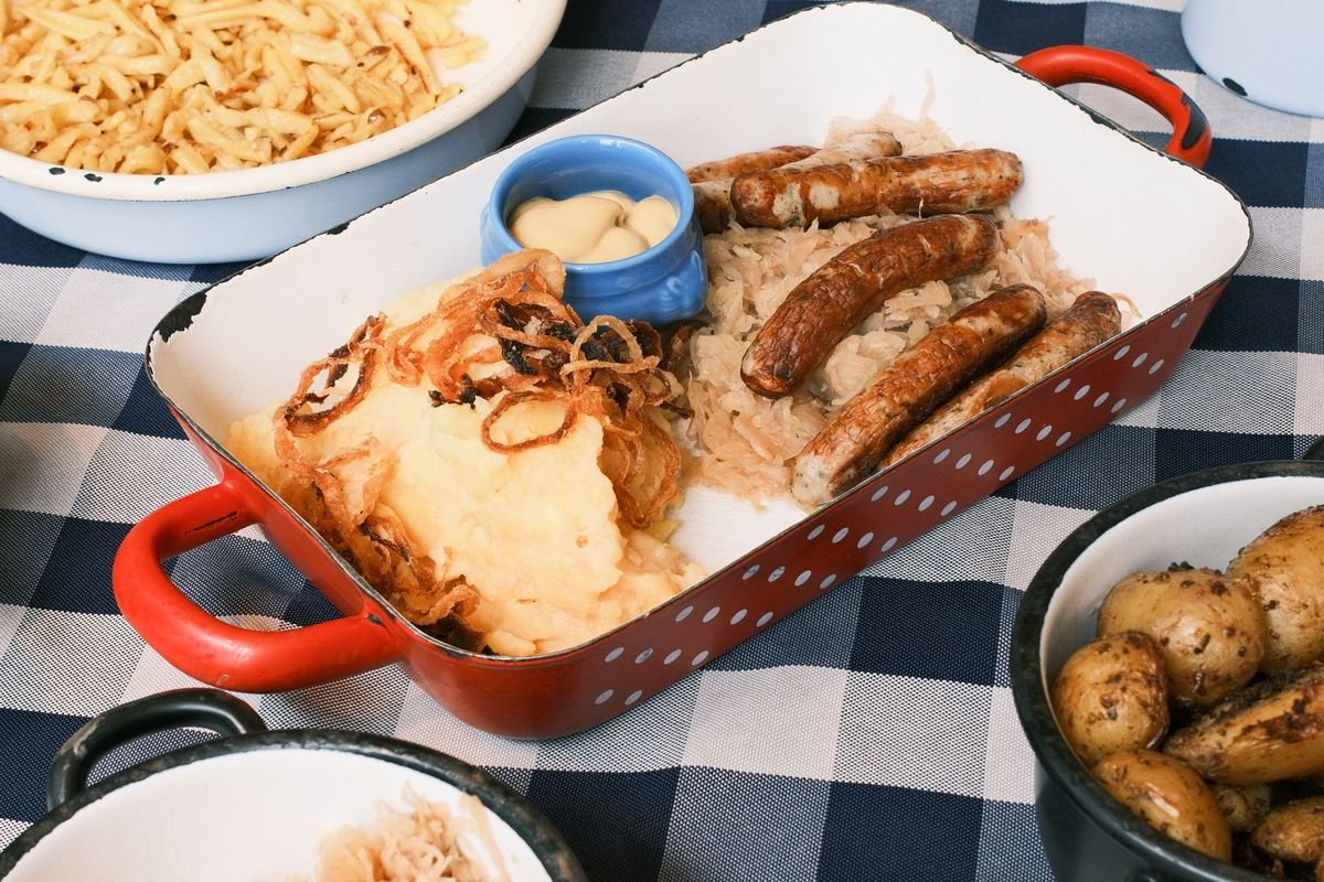 Beer-Braised Bratwurst with Sauerkraut and Buttery Mash