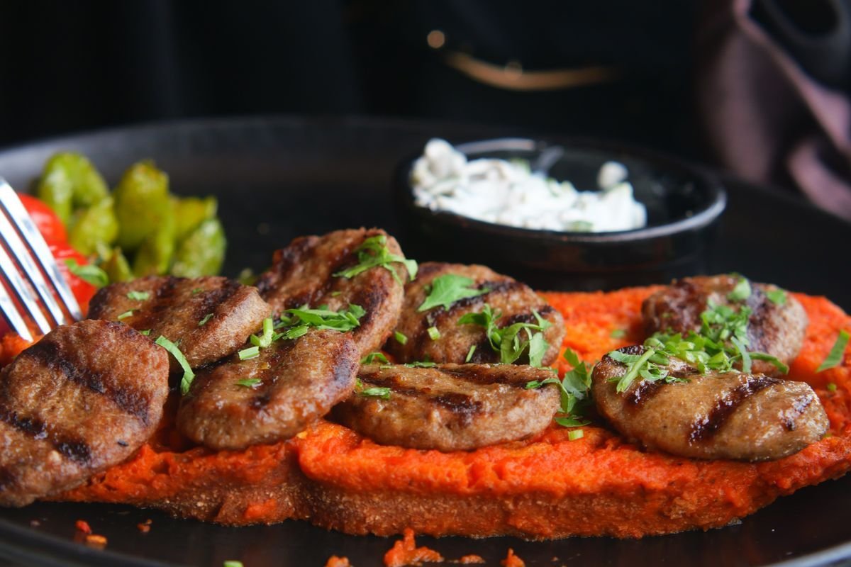 Grilled Kofte over Red Pepper Walnut Sauce