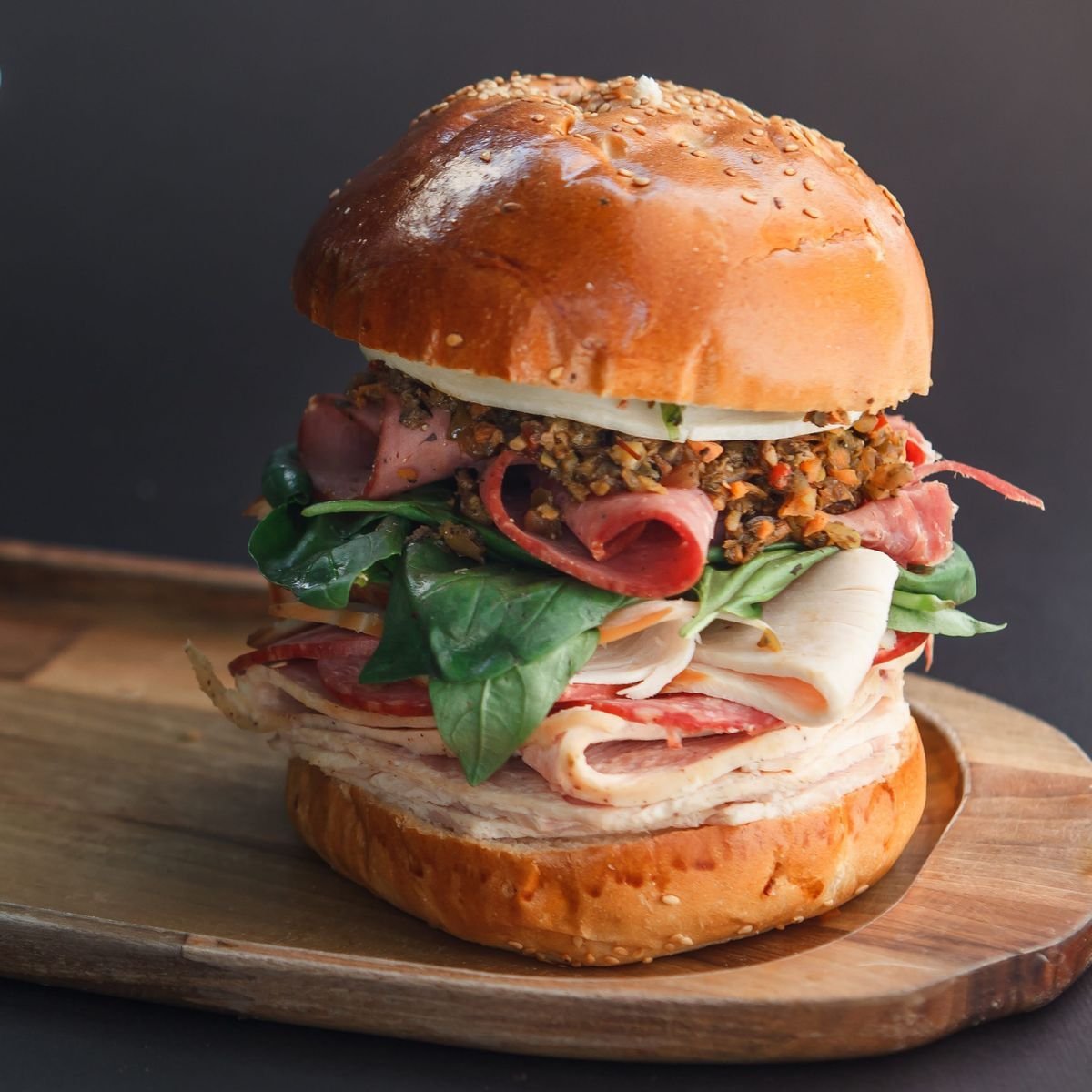 Muffuletta-Style Deli Stack on a Seeded Bun