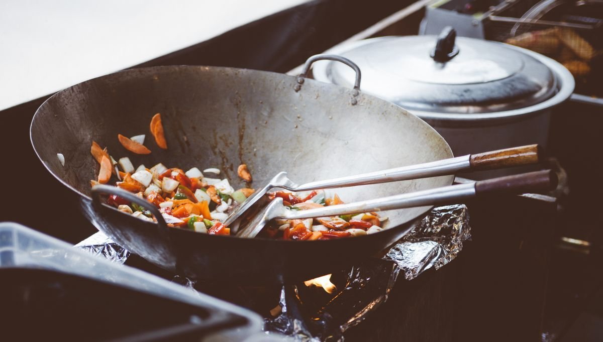 Peppers and onions tossed in a wok over a high flame